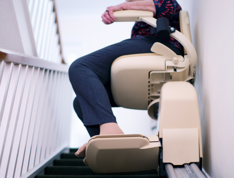 Image of an elderly woman on a stairlift
