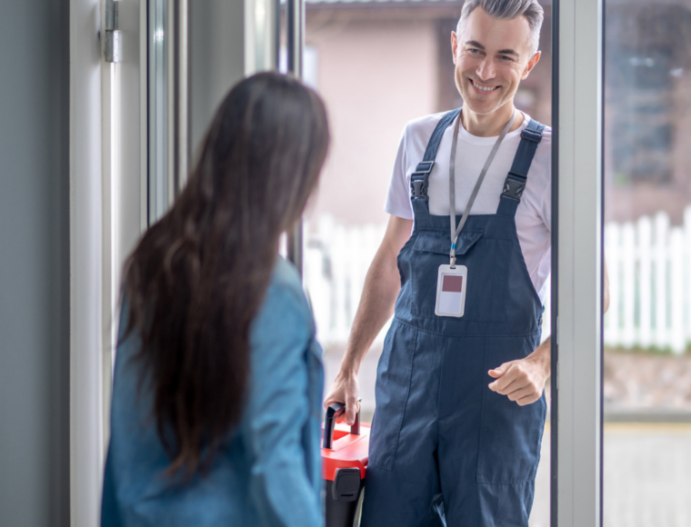 Image of a male contractor at the door and being greeted by the person in the property