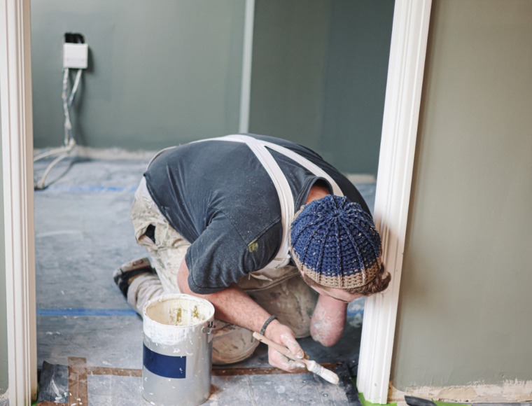 Image of a male decorator preparing a room for redecorating