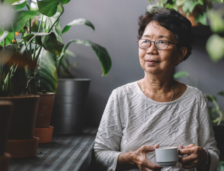 Image of an elderly woman drinking tea indoors