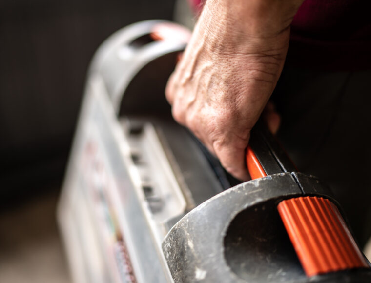 Close up image of someone holding a toolbox